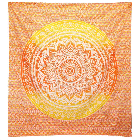 A vibrant orange and yellow mandala wall hanging with intricate white patterns used as a beach spread or decor