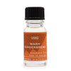 A clear glass bottle with black cap holds warm gingerbread fragrance oil labeled ancient wisdom with allergen declarations