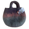 A felted bag with gradient purple to green colors made of wool featuring sturdy handles called fairy garden tote