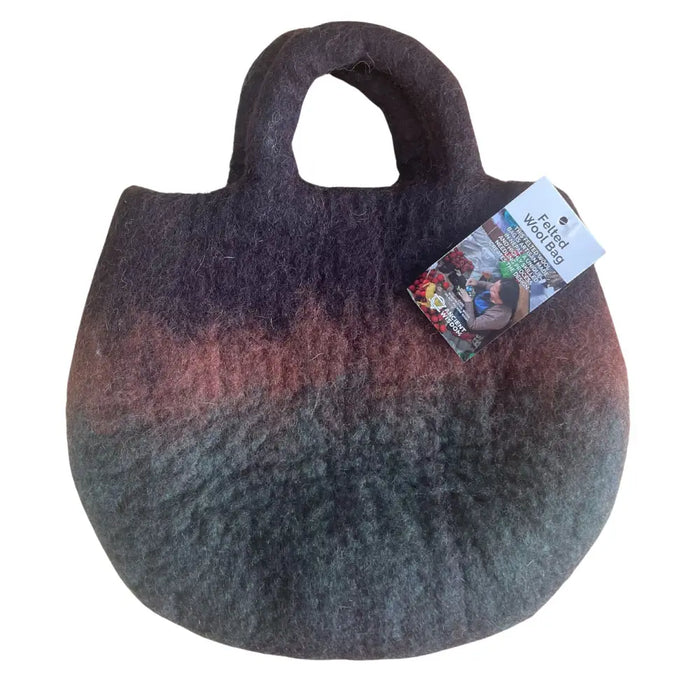 A felted bag with gradient purple to green colors made of wool featuring sturdy handles called fairy garden tote
