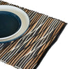 Handwoven water hyacinth placemat with textured black white and natural brown stripes in white waves pattern