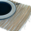 Beige woven water hyacinth placemat with natural tiger textured stripes and frayed edges for dining use