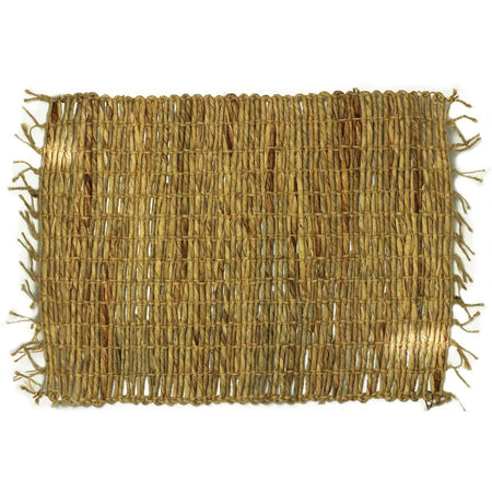 Natural woven water hyacinth placemat in beige with a rustic textured pattern and frayed edges made from dried reeds