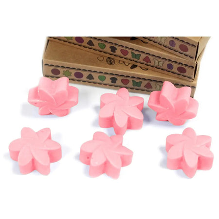 Pink flower-shaped wax melts made from palm waxes shown in a box of six classic rose scented bars