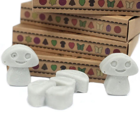 White smiling mushroom shaped erasers with matte finish and carved faces beside dark patchouli wax melts palm waxes box of 6