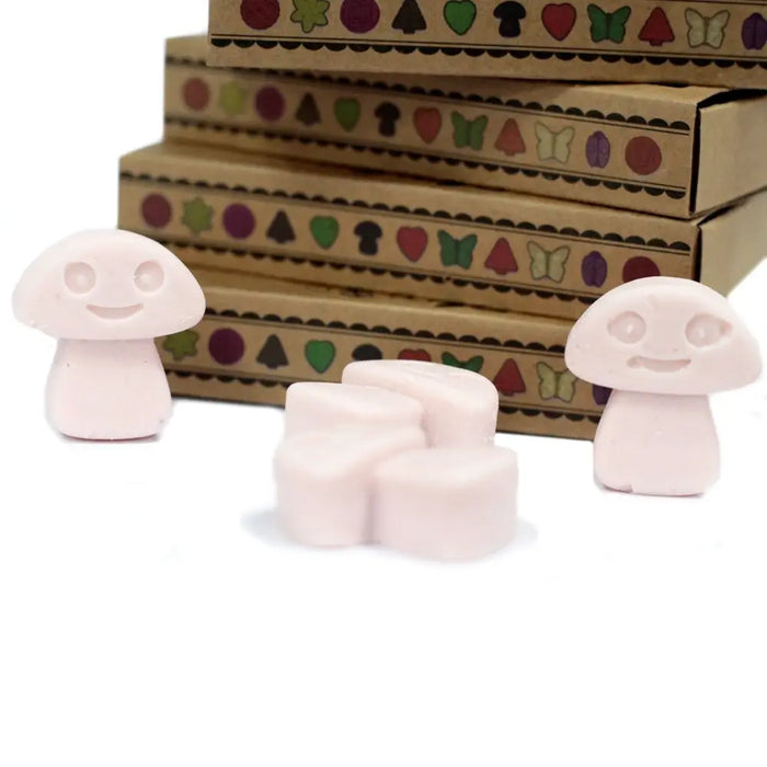 Pastel pink mushroom-shaped wax melts with smiling faces made from palm waxes scented dark sandalwood box of 6