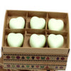 Six pale green heart-shaped palm waxes wax melts in a brown box with decorative patterned borders mint and menthol scent