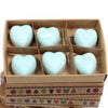 Six light blue heart-shaped palm waxes wax melts in a brown cardboard box with decorative patterns nagchampa scent
