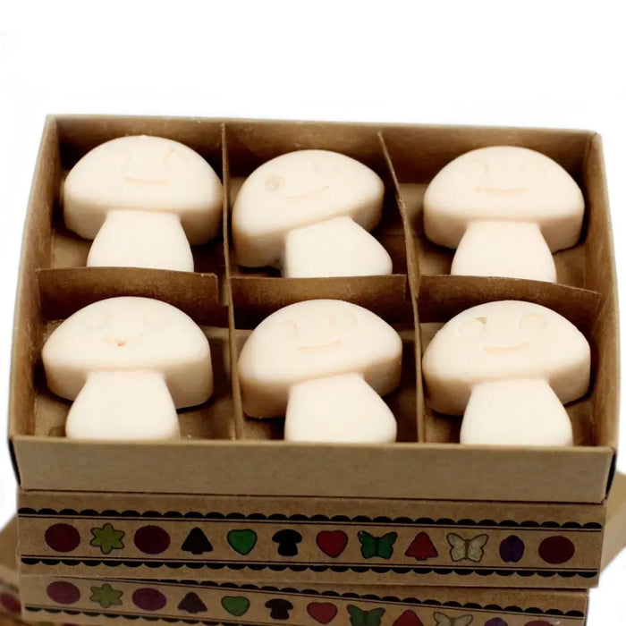 Six off-white mushroom-shaped palm waxes wax melts in a decorative cardboard box vanilla nutmeg scent