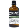 A brown glass bottle of wheatgerm organic base oil with a black cap and allergen declarations for hair care