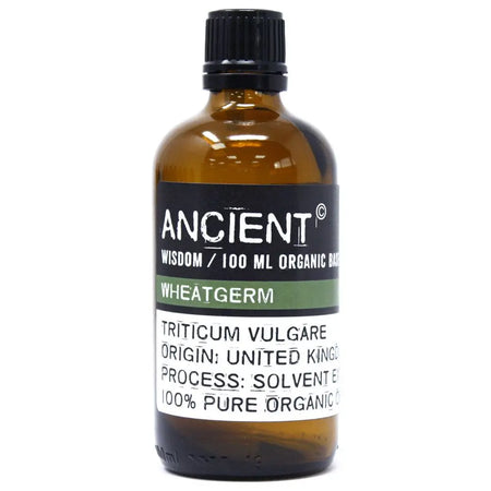 A brown glass bottle of wheatgerm organic base oil with a black cap and allergen declarations for hair care