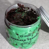 Emerald green polka dotted jar of ancient wisdom dubai whipped soap with dark purple glittery emerald truffle whipped soap content