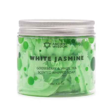 A clear glass jar with silver lid holds light green whipped soap with white tea and gooseberry swirls and dots