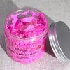 Pink charlotte whipped soap in a clear jar with floral design and silver lid featuring peel oil scent and texture
