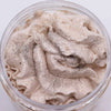 A creamy light beige whipped soap with a warm gingerbread scent and silver glitter in a clear plastic jar