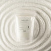 A clear plastic pouch of unfragranced white candle sand labeled luxury candle sand by ancient wisdom 300g