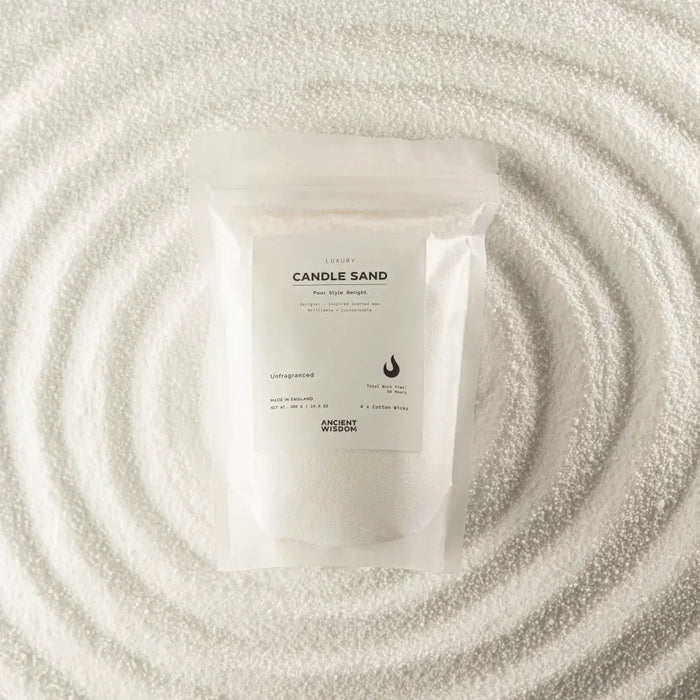 A clear plastic pouch of unfragranced white candle sand labeled luxury candle sand by ancient wisdom 300g