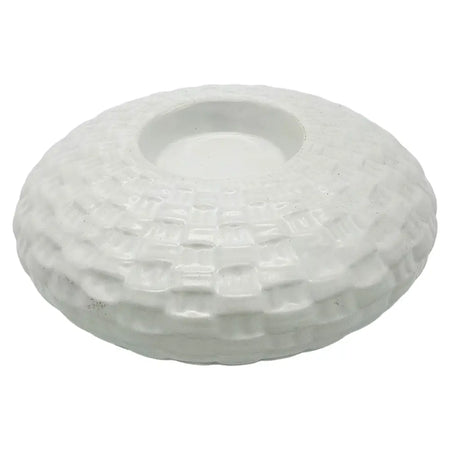 White ceramic tealight holder with a textured woven pattern and a central circular well for a candle