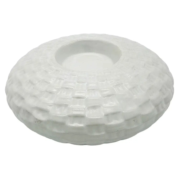 White ceramic tealight holder with a textured woven pattern and a central circular well for a candle
