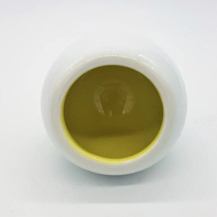 White ceramic tealight holder filled with smooth golden yellow liquid in traffic lights design with three colour options