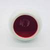 A white ceramic tealight holder bowl filled with deep red liquid from the traffic lights three colour options set