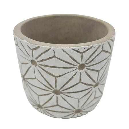 White geometric plant pot made of ceramic with a starburst pattern in muted gray tones