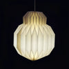 White origami paper pendant light with a geometric faceted globe shape in cream color for indoor use