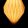 A warm translucent amber pendant shape lamp with a white origami faceted shade made of geometric material
