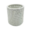 White porcelain tealight holder with intricate swirling leaf pattern cutouts for decorative candle use