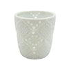 White porcelain tealight holder with intricate lace-like cutout patterns in a moroccan design style