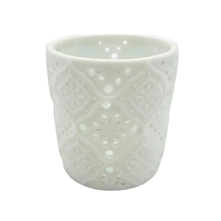 White porcelain tealight holder with intricate lace-like cutout patterns in a moroccan design style