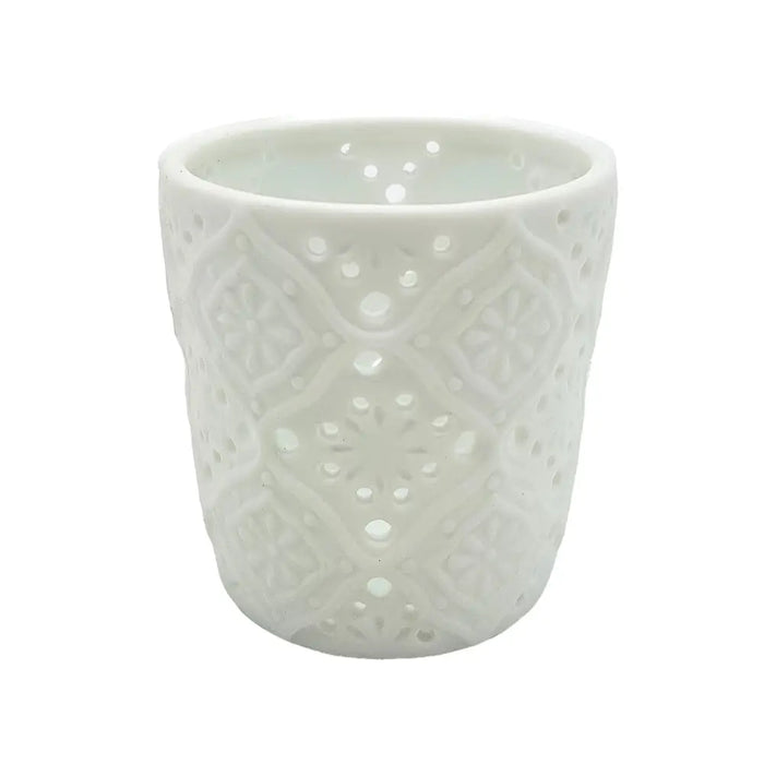 White porcelain tealight holder with intricate lace-like cutout patterns in a moroccan design style