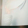 White porcelain tealight holder with a white ceramic vase design and embossed frangipane floral pattern
