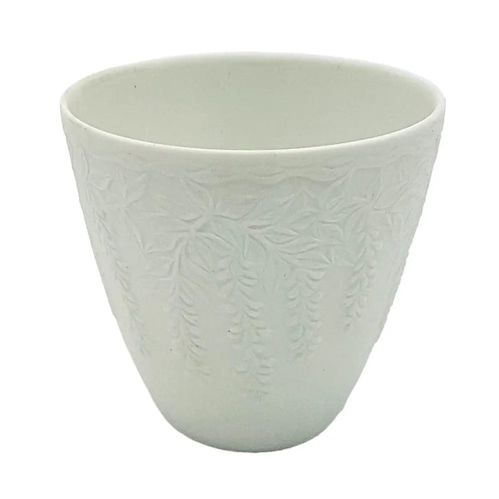 White porcelain tealight holder with embossed wisteria floral pattern in a delicate white ceramic cup design