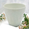 White porcelain tealight holder with embossed wisteria leaf design in a white ceramic planter style