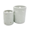 White porcelain tealight holders with star design cutouts in two sizes for candles or votives