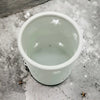 White porcelain tealight holder with star design cutouts shown in one of two sizes for votive candles