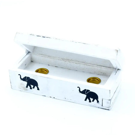 White-washed mango wood incense holder box with distressed finish, black elephant silhouettes, and two gold candle holders inside