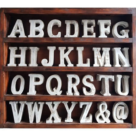 White distressed wooden alphabet letters in a rustic dark wood tray made from mango wood