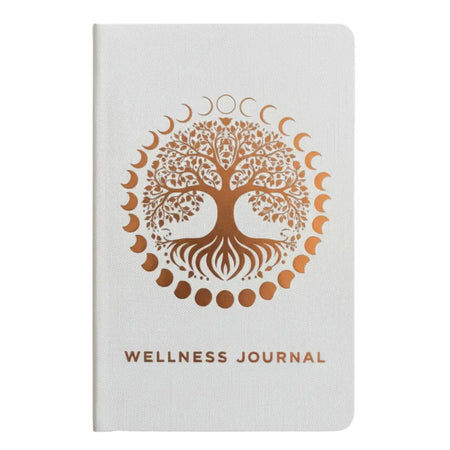 White wellness journal with textured cover and rose gold tree of life encircled by moon phases for wellness journey