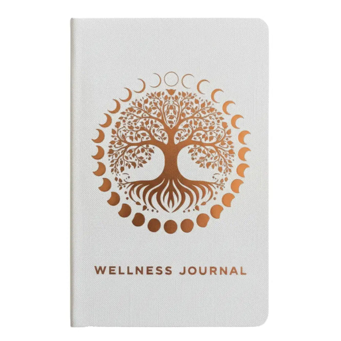 White wellness journal with textured cover and rose gold tree of life encircled by moon phases for wellness journey