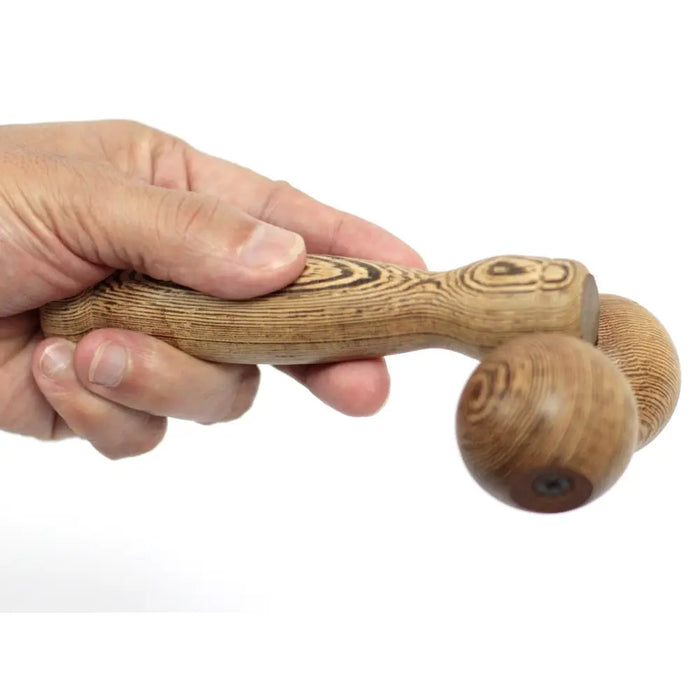 A handcrafted wooden hand ball roller with a natural wood grain finish and two textured spheres for massage