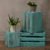 Stacked wooden storage crates in turquoise wash with distressed paint and vertical slats made from albesia wood