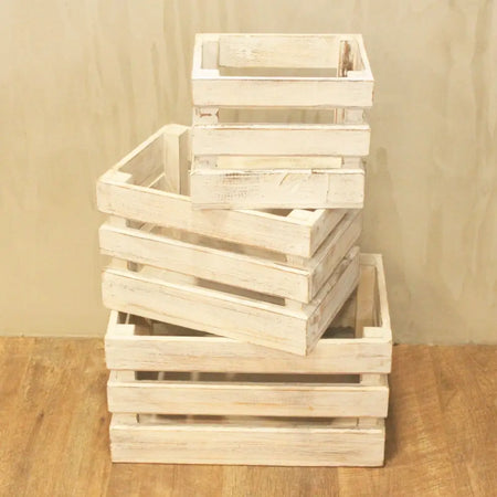 Stack of three distressed white wooden storage crates with rustic weathered finish for wooden storage use