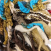 A wool hat with tassels flowers and plaits made from colorful hand dyed wool yarns in earthy tones and vibrant blues