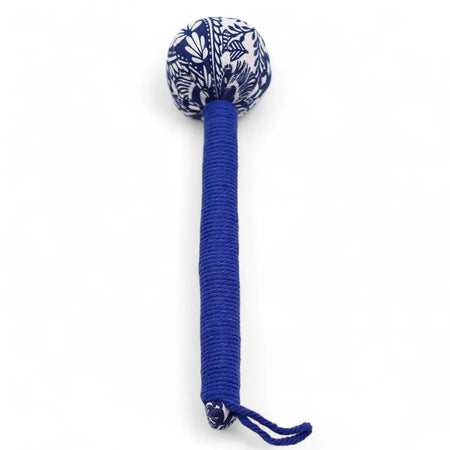 A blue cord wrapped wormwood massage hammer with a spherical head covered in white floral patterns on navy fabric