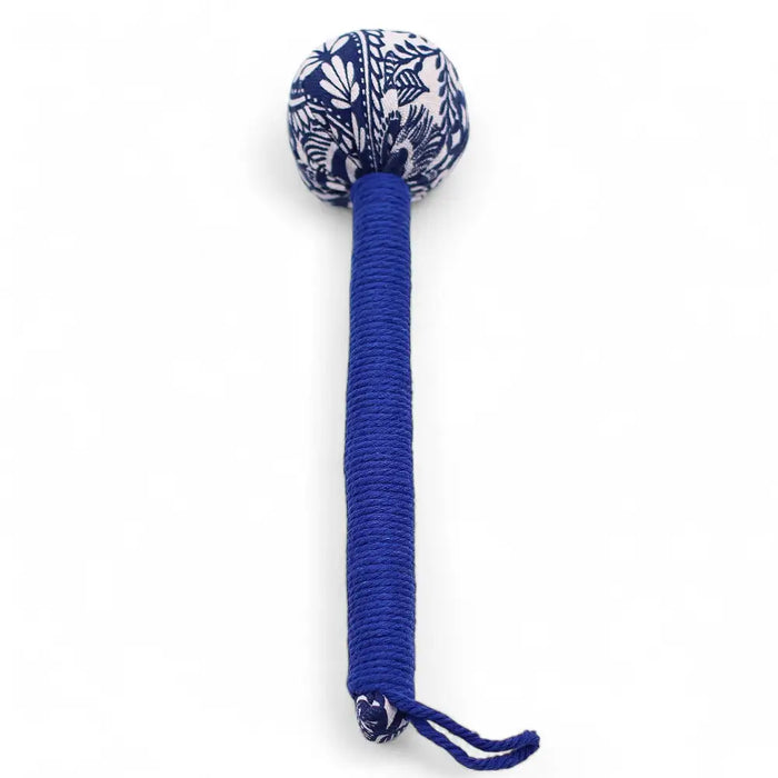 A blue cord wrapped wormwood massage hammer with a spherical head covered in white floral patterns on navy fabric