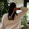 Lavender-colored wormwood massage hammer with a textured handle and patterned spherical head for massage use