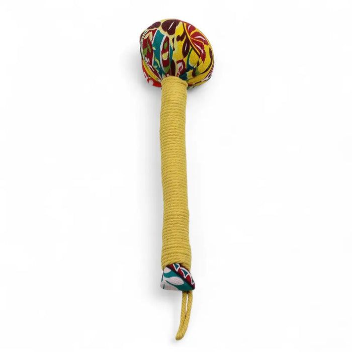 A wormwood massage hammer with a lemon yellow rope handle and colorful floral fabric head like a handcrafted maraca