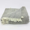 Gray and white herringbone patterned woven woollen shawl with soft fringed edges for cozy use